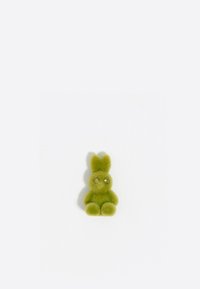 Juguete de conejito de peluche verde con una textura suave, cuerpo redondeado, orejas cortas y ojos brillantes, que presenta un acabado suave y peludo.