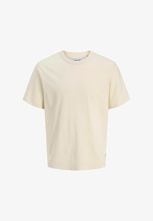 Hellbeige Baumwoll-T-Shirt mit rundem Halsausschnitt, kurzen Ärmeln und lockerer Passform. Mit minimalistischer Markenkennzeichnung nahe dem Saum. Glatte Textur.