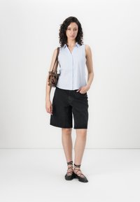 Light blue, sleeveless button-up shirt with a collar; black denim shorts; brown handbag; black lace-up flats. Minimalist design, smooth texture.