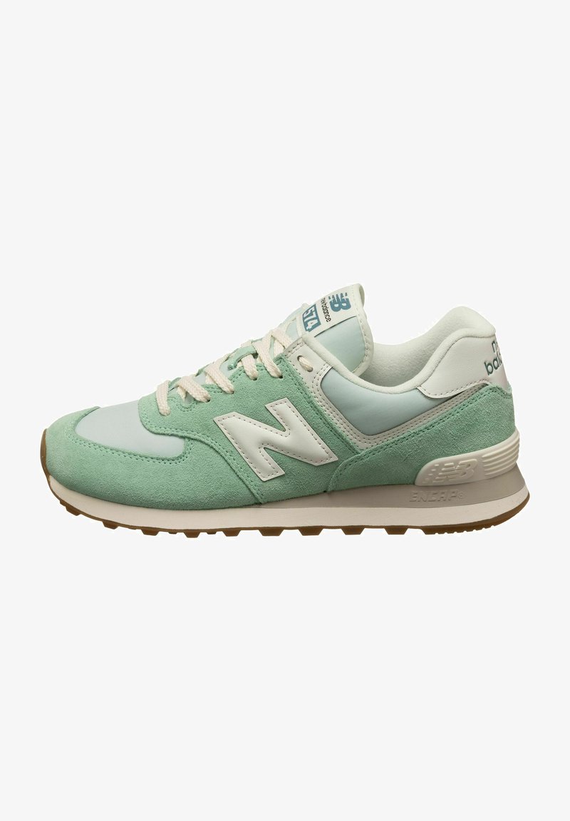 Baskets basses New Balance vert menthe et blanc avec des lacets beige, une semelle rembourrée et un logo sur le côté et la languette.