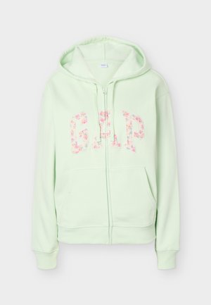Light green zip-up hoodie with front pockets and floral-patterned "GAP" lettering across the chest.