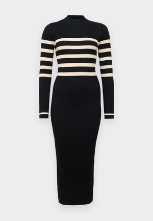 Abito a maglia nero a coste con maniche lunghe e scollo alto. Presenta strisce beige orizzontali lungo il torace e le maniche. Silhouette aderente.