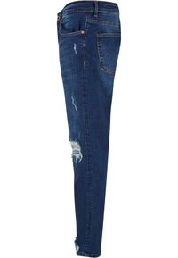 Jeans en denim bleus, coupe slim, avec des accents déchirés et une finition délavée. Design à cinq poches avec coutures visibles et ourlet effiloché.
