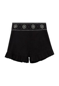 Black shorts with a ruffled hem, featuring a decorative waistband with circular embellishments and small studs for added detail.