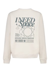 Cream sweatshirt featuring a graphic print on the back. Text reads "I NEED Space" with planets and a barcode design, highlighting a textured finish.