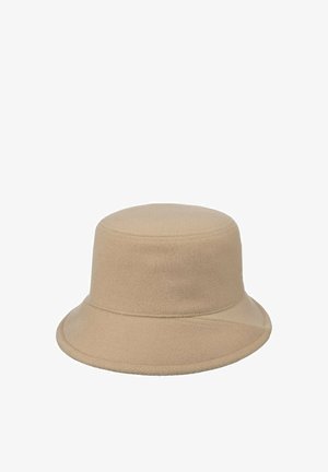 Beige bucket hat with soft, felt-like texture and a gently downward-sloping brim, featuring subtle stitching details around edges.