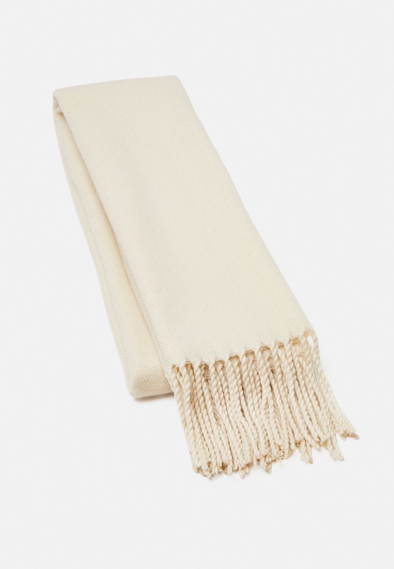 Beige huivi, joka on valmistettu pehmeästä kankaasta, jossa on sileä pinta ja fringet. Suunnittelu on yksinkertainen ja suorakulmainen.