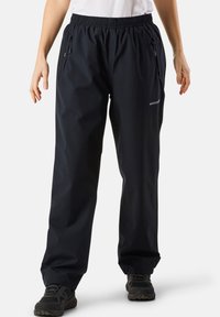 Black waterproof pants with an elastic waistband, zipper pockets, and a reflective accent. Made from a smooth, lightweight material.