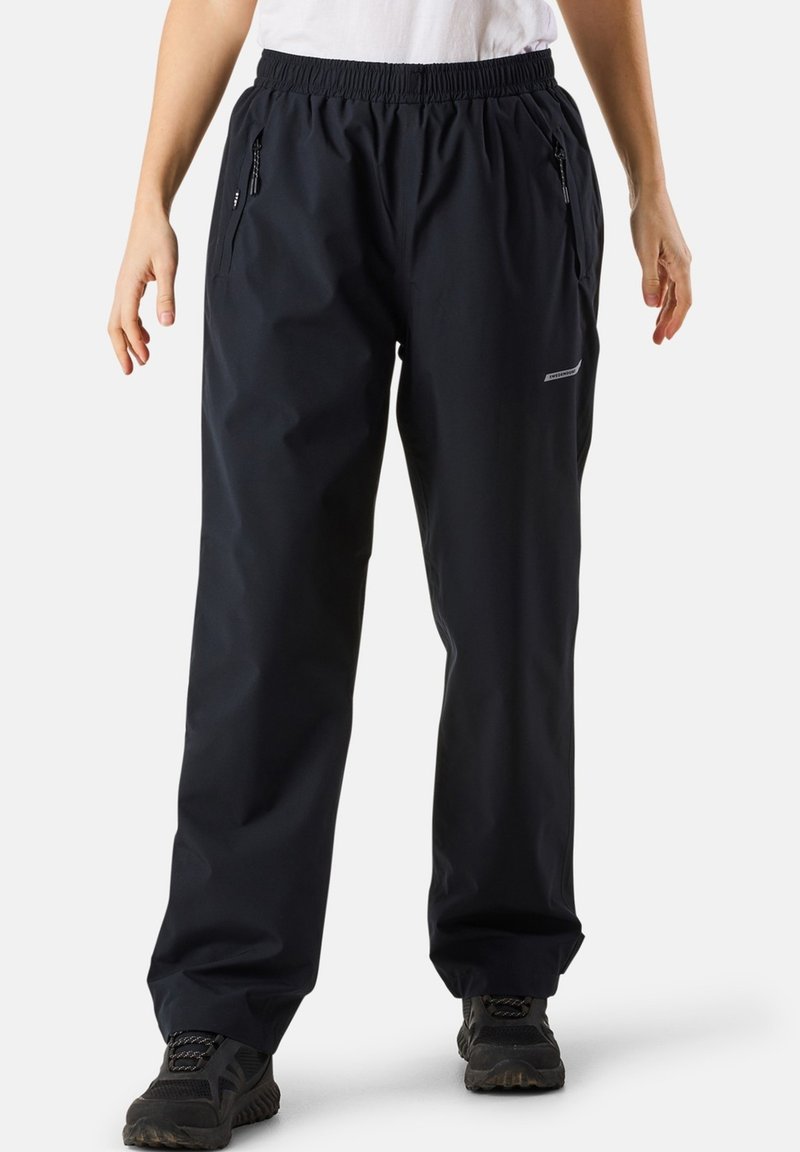 Black waterproof pants with an elastic waistband, zipper pockets, and a reflective accent. Made from a smooth, lightweight material.