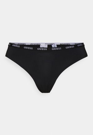 Zwarte bikini slip met een brede elastische tailleband met het witte "GUESS" logo. Glad van textuur, met een middelhoge taille en een getailleerde pasvorm.