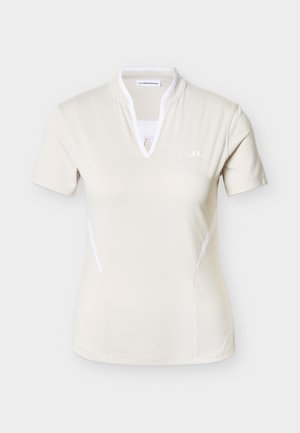 Tricou polo crem cu mâneci scurte, decolteu în V și accente albe, realizat dintr-un material neted și respirabil. Are un mic logo pe piept.