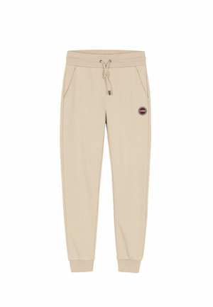 Beige sweatpants met een elastische tailleband, trekkoord, twee zijzakken en een ronde logo patch op de linkerbovenbeen. Met boord aan de enkels.