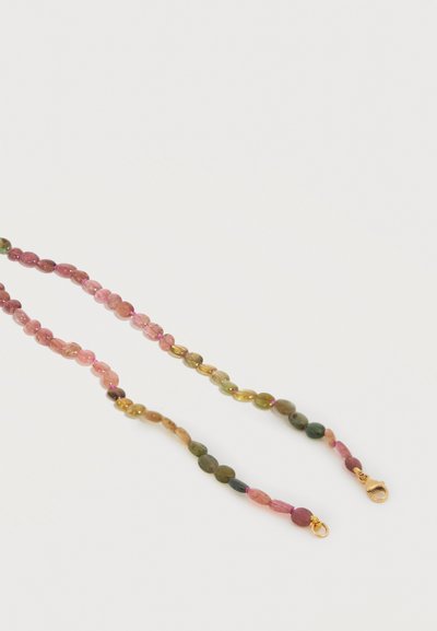 Perles ovales multicolores enfilées sur un collier avec fermoir mousqueton doré et anneau sur un fond clair.