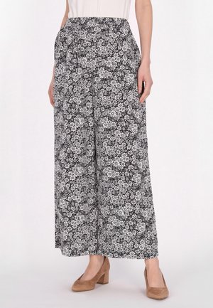 Zwart-witte, bloemenprint wijde broek met een elastische tailleband, gemaakt van lichtgewicht stof. Heeft een vloeiende ontwerp en een enkel-lengte snit.