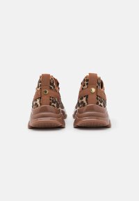 Sneaker marroni e neri con motivo, realizzati in materiale resistente, dotati di tacco rialzato, suola testurizzata e linguette sul retro.