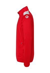 Red softshell jacket with a high collar, white shoulder accents, zippered side pockets, and a logo on the upper left sleeve.