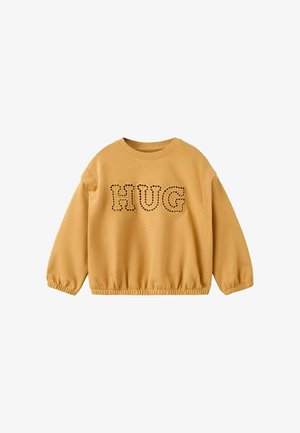 Langærmet sweatshirt i sennepsgul med elastiske manchetter og kant, med ordet "HUG" i store, syede bogstaver tværs over brystet.
