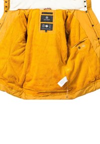 Yellow inner lining of a jacket made of soft fleece, featuring a smooth, shiny exterior with multiple pockets, and a label inside.