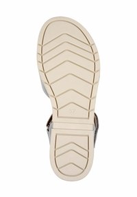 Sandal grigio con una suola in gomma testurizzata e antiscivolo, caratterizzata da un motivo a zigzag. Le dimensioni e le tonalità neutre sono visibili nel design.