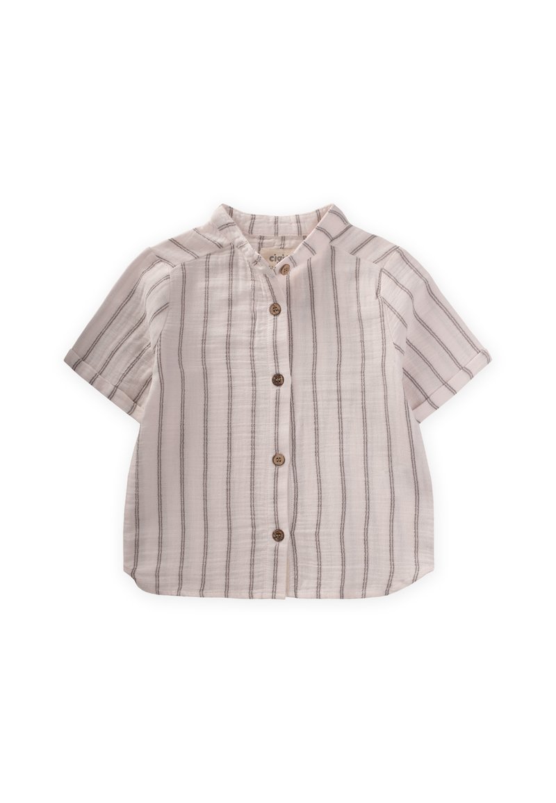 Īsām piedurknēm krekls gaiši bežā krāsā ar plānām vertikālām svītrām. Tam ir apkakle, pogu aizdare un mīksta, teksturēta auduma virsma.