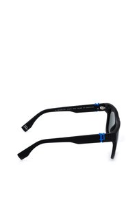 Lunettes de soleil noires avec montures rectangulaires, verres polarisés teintés et logos décoratifs bleus sur les branches et les charnières.