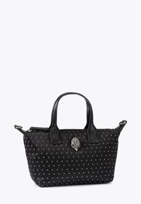 Czarna torebka z tkaniny z srebrnymi ćwiekami, o wyraźnym kształcie, z podwójnymi skórzanymi uchwytami oraz ozdobnym elementem metalowym na przodzie.