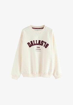 Cremefarvet sweatshirt med v-hals, prydet med maroon "DALLAS '78" tekst og supplerende tekst nedenfor. Manchetter ved ærmerne og i kanten. Blødt stof.