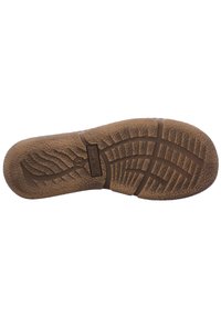 Suela de zapato de goma marrón con superficie texturizada. Presenta un diseño de banda de rodadura único, que incluye ranuras y pequeñas crestas para mayor tracción.