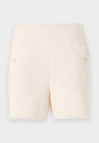 Cream-colored shorts made of textured fabric, featuring two front pockets with button accents and a frayed hem.