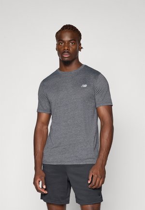 Gray athletic short-sleeve shirt with a crew neckline and a small white logo; worn with dark shorts, showcasing a fitted design.