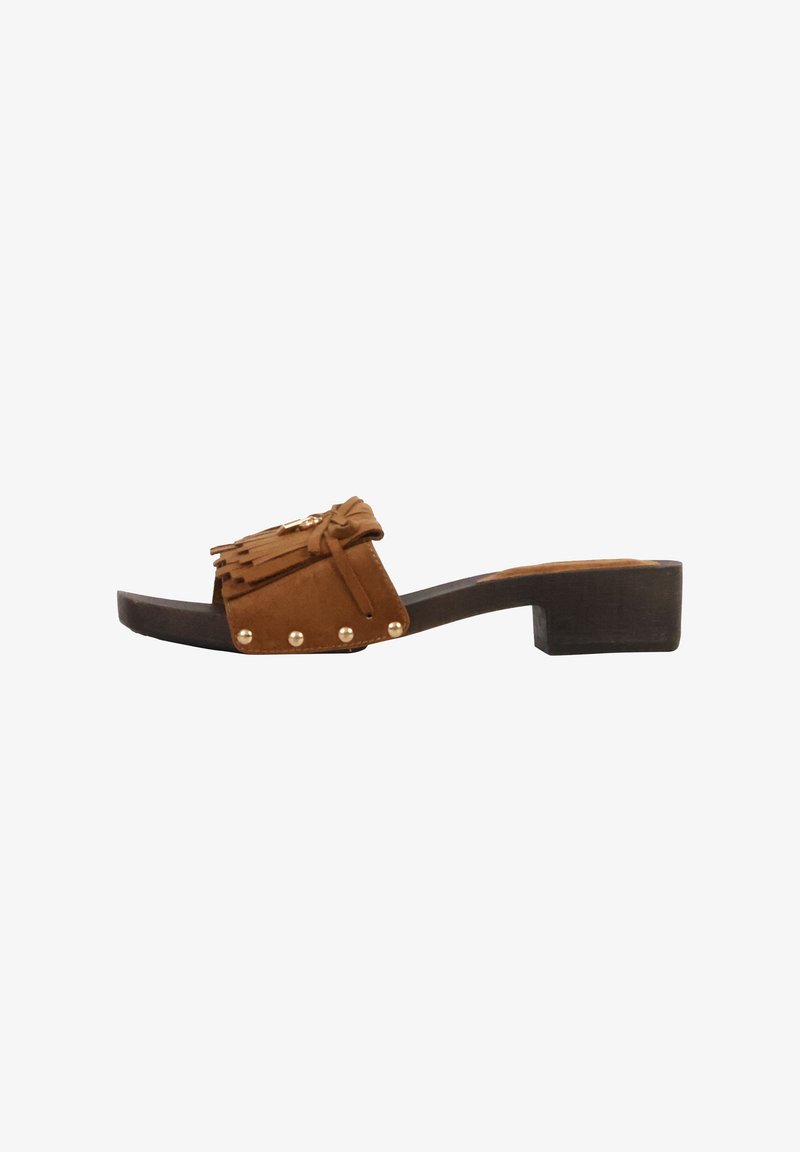 Mule ouverte en daim marron avec talon bloc, détails à franges, bride nouée et accents de clous dorés sur le dessus.