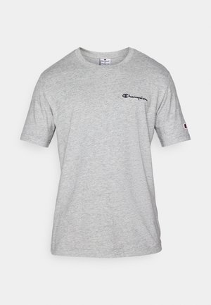 Harmaa lyhythihainen t-paita, joka on valmistettu pehmeästä puuvillasekoitteesta. Paidassa on pieni tumma logo vasemmassa ylärinnassa ja logo yksityiskohta hihassa.