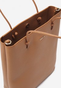 Borsa tote in pelle marrone con una finitura testurizzata. Presenta due manici a spalla e un logo dorato sulla parte anteriore. Design aperto con bottoni a pressione.