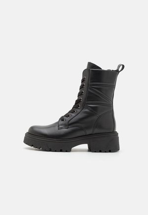 Black mid-calf boots made of smooth leather, featuring a chunky sole, round toe, lace-up front, and rear pull tab.