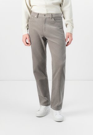 Gray corduroy pants with vertical stripes, featuring a button and zipper closure, front pockets, and a straight-leg cut. Worn with white sneakers.
