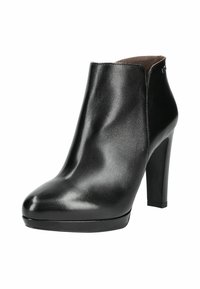 Bottines noires en matériau synthétique brillant, avec un bout pointu, un talon haut et un design épuré et lisse.