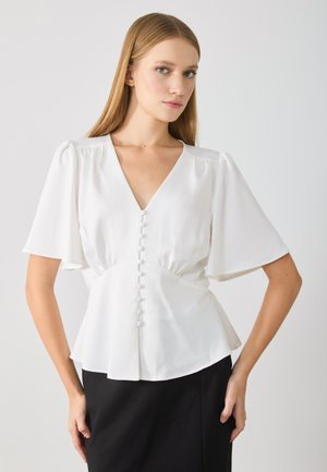 Hvit kortermet bluse med V-hals, med en tettsittende midje og sju matchende knapper foran; glatt tekstur, lett stoff.