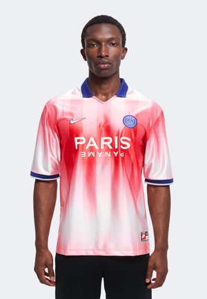 Mann trägt ein rot-weiß verlaufendes Paris Saint-Germain Fußballtrikot mit blauem Kragen und Logo auf der Brust.