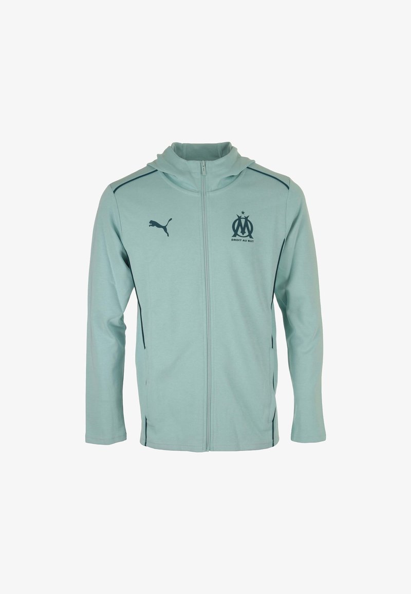 Giacca con zip di colore azzurro chiaro realizzata in materiale morbido, con cappuccio, logo Puma nero ed emblema del club di Marsiglia sul petto.