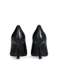 Chaussures à talons hauts en cuir noir avec un bout pointu, un design épuré et une finition brillante ; dotées d'un talon aiguille étroit et de détails de couture subtils.