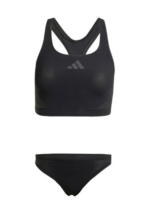 Zwarte sportbeha met een ronde halslijn, gekruiste rug en een soepele textuur. Inclusief bijpassende zwarte bikinibroek met subtiele zijdetails.