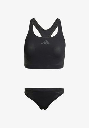 Zwarte sportbeha met een ronde halslijn, gekruiste rug en een soepele textuur. Inclusief bijpassende zwarte bikinibroek met subtiele zijdetails.