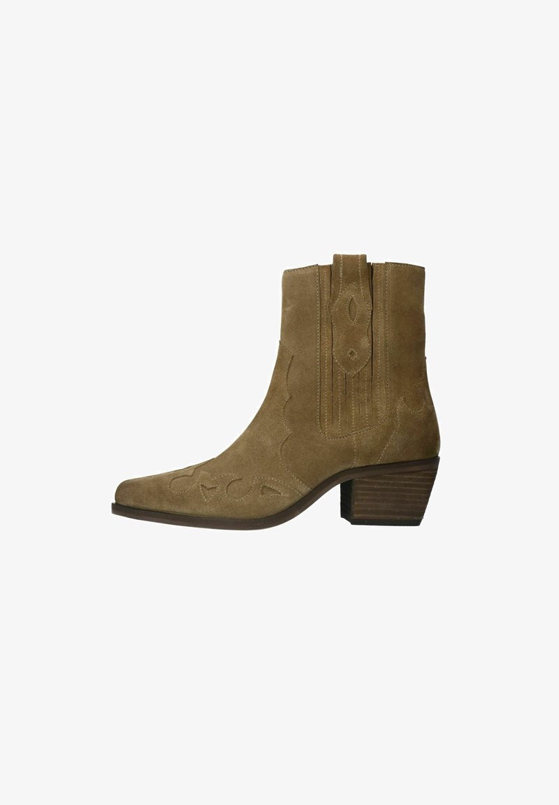 Brown suede ankle boot with pointed toe, scalloped stitching, and block heel. Features decorative cutouts on the toe area.