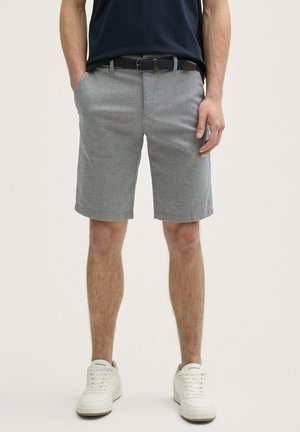 Gray shorts with a textured pattern, side pockets, and a straight leg design, paired with white sneakers. Features a dark belt.