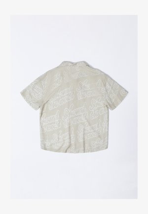 Short-sleeve shirt in light beige, featuring all-over white script design. Lightweight fabric with a relaxed fit and standard collar.