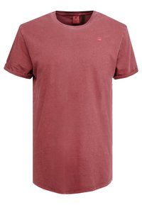 Lyhythihainen, pyöreäkauluksinen t-paita pölyruusun värissä, valmistettu pehmeästä puuvillasta. Paita sisältää hienovaraisen logon rinnassa ja käärityt hihat.