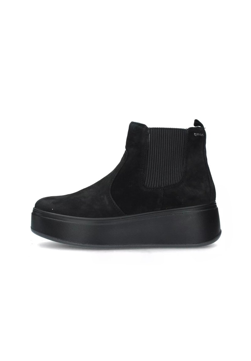 Stivaletti neri in suede con pannelli laterali elastici, punta rotonda e suola piatta spessa, caratterizzati da una finitura opaca liscia.