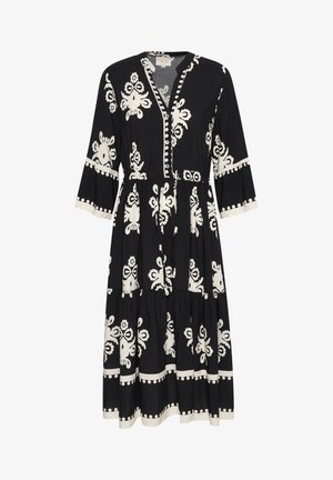 Mustmustreening mustritekirjaga, pikad varrukad, V-kaelus, nööbid ees ja kihiline seelik kontrastse servaga varrukatel ja allääridel.