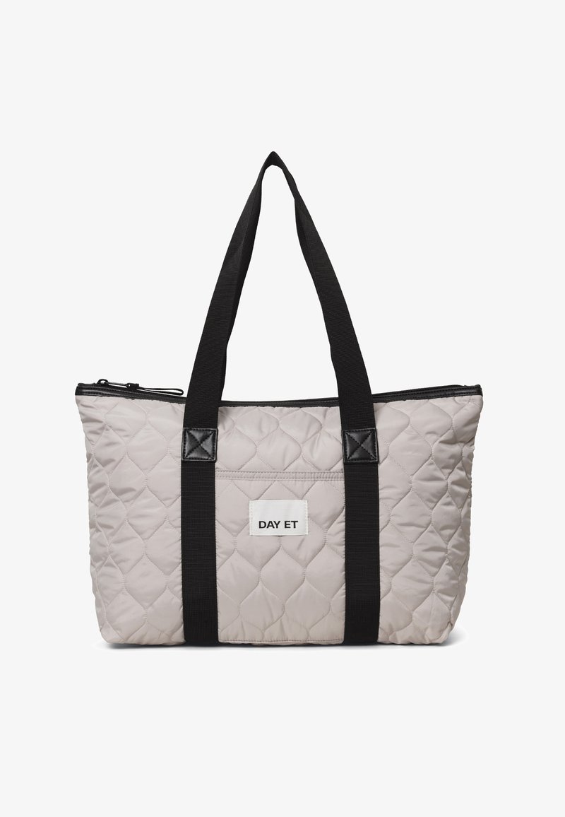 Quilted tote bag in light gray with black accents. Features a zip closure, two black straps, and a white label displaying "DAY ET."