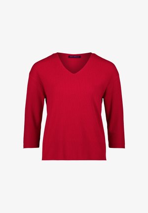 Rode geribbelde gebreide trui met een V-hals en driekwart mouwen. Lichtgewicht stof met een gestructureerde afwerking. Merklabel zichtbaar.